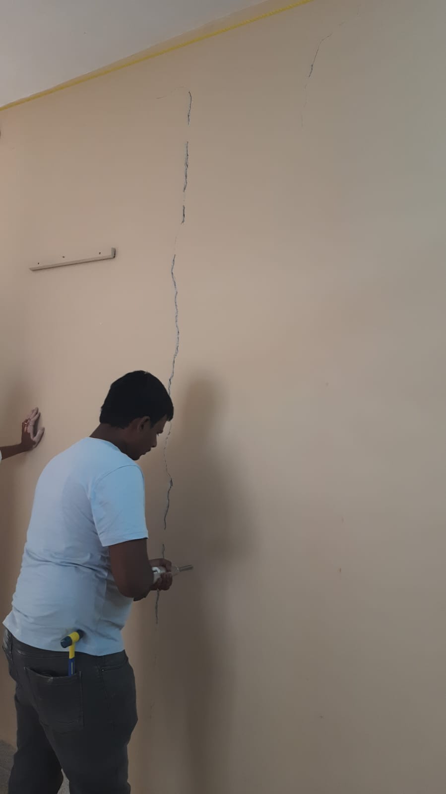 Wall crack repair in progress